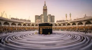 A wide-angle view of the Holy Kaaba in Makkah with pilgrims performing Tawaf during a Bukhari Tours Hajj journey.